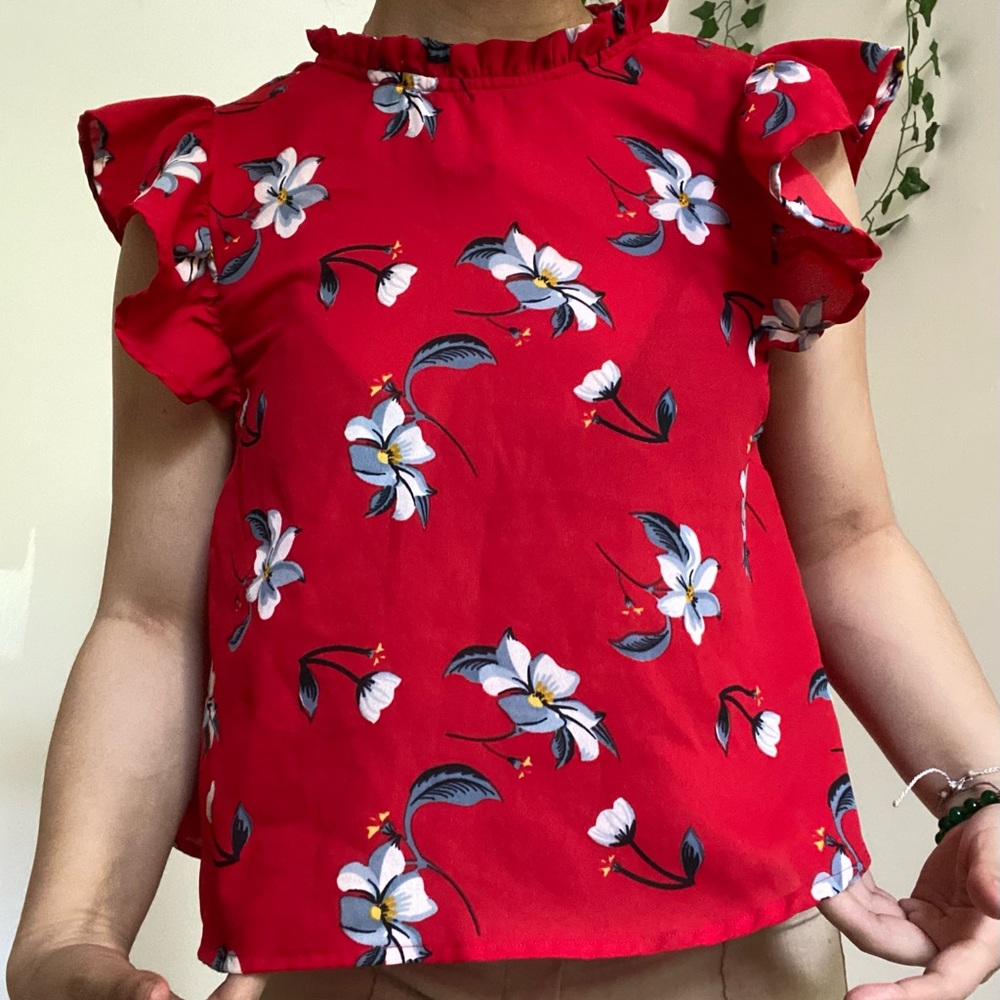 Red with white and blue flowers. Ruffled shoulders. Sleeveless.